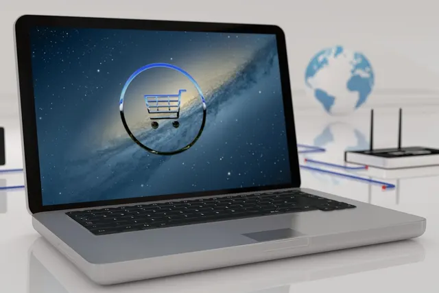 3D render of a silver laptop showing a shopping cart icon, with a router, globe and network cables on a white desk