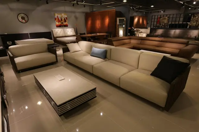 Furniture showroom with beige sofas, armchairs and a low coffee table