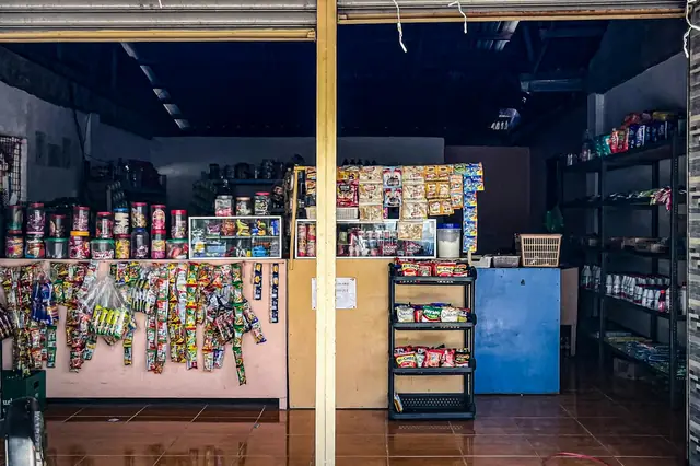 Small neighborhood convenience store with snacks hanging behind the counter