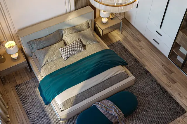 Neatly made double bed in a modern hotel bedroom