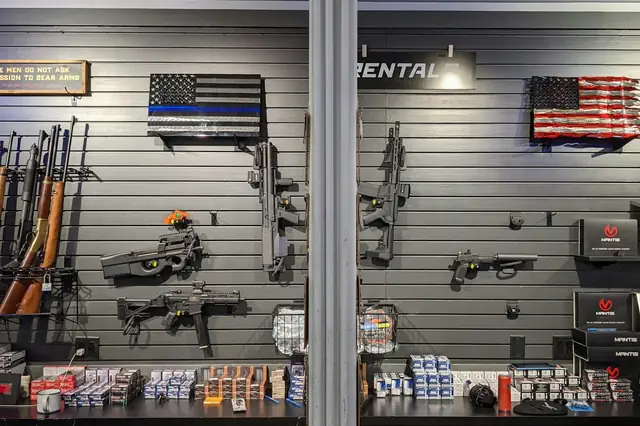 Gun store wall with rifles and flags on display
