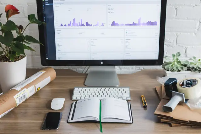 Desktop monitor showing bar-chart analytics on a tidy desk