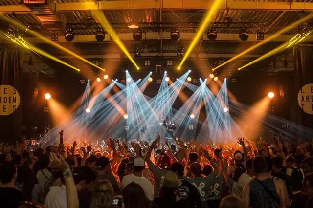 Crowd at a concert under bright stage lights