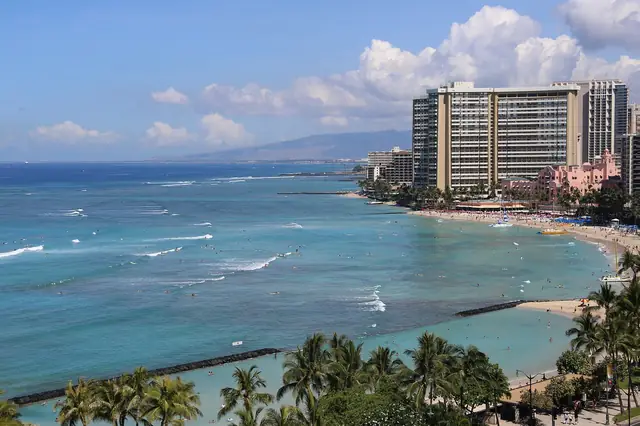 Beachfront hotels along turquoise water and a sandy shoreline