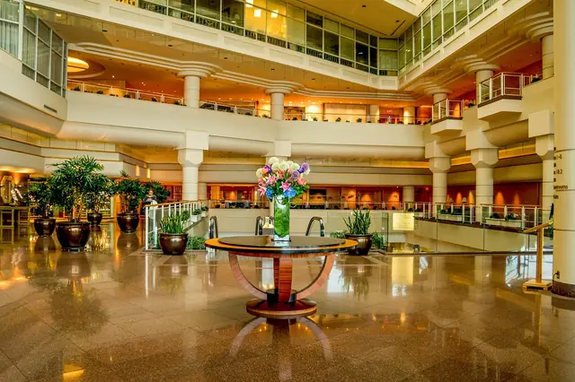Grand hotel atrium lobby with balconies and a flower centerpiece
