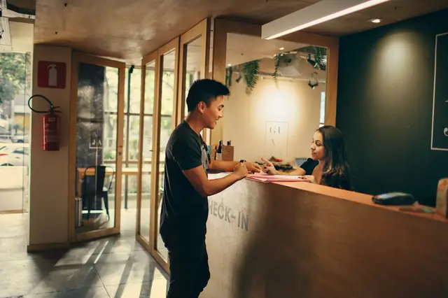 Guest checking in at a hotel reception desk