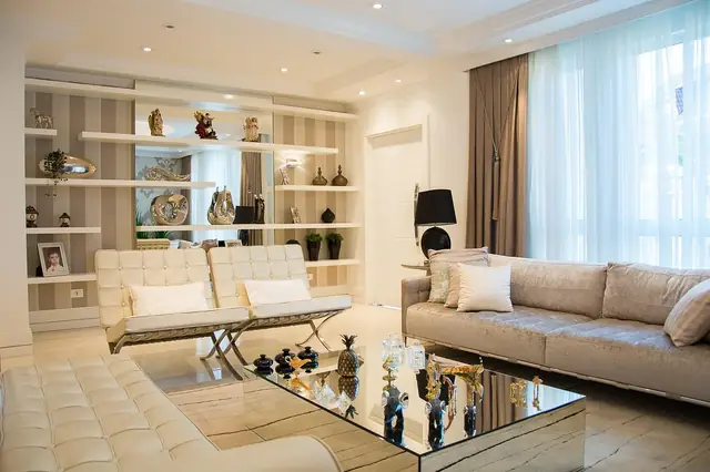 Upscale living room with cream sofas and built-in shelving