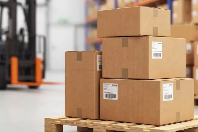 Stacked shipping boxes on a pallet in a warehouse with forklift