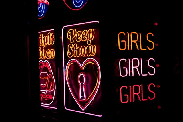 Neon club signs glowing in the dark