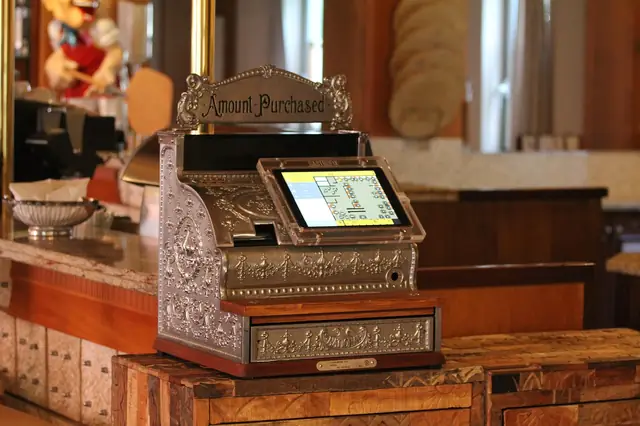 Antique ornate cash register fitted with a modern touchscreen