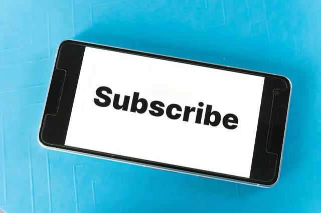Smartphone showing a subscribe message on a blue background