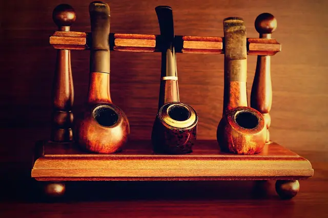 Wooden tobacco pipes standing in a pipe rack