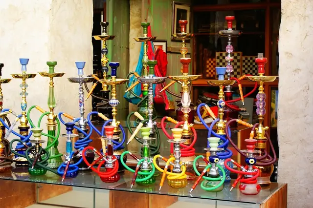 Colorful hookahs displayed on a glass shop counter